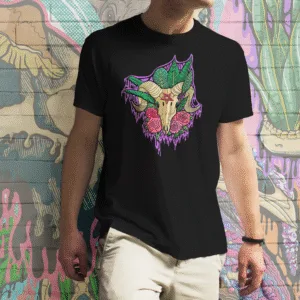 A Drippy Baphomet Skull tee in black, featuring a haunting goat skull with curling horns, lush green leaves, red roses, and an ominous pentagram on the forehead. The vivid purples, reds, and greens pop against the dark background, perfect for occult art lovers, gothic fashion fans, and horror enthusiasts.