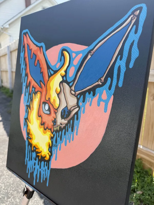 Side view of the Drippy Flareon Skull painting on canvas. Bright fire tones and skeletal details blend into neon drips, emphasizing the painting’s hand-painted texture and unique composition.