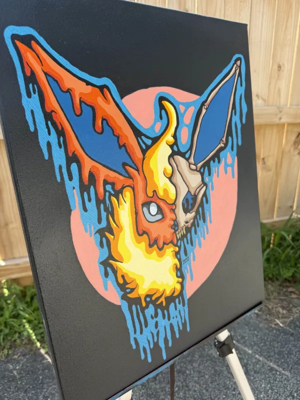 Angled view of the Drippy Flareon Skull acrylic painting, showing textured brushstrokes and depth. The fiery skull design melts into blue drips, with vibrant colors against the black canvas edges.