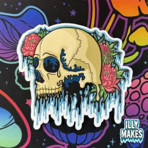 decal depicting an intricate melting skull in cream and teal hues surrounded by lush pink flowers and green leaves, with a unique reflective color-shifting finish, gothic floral art by illymakes.