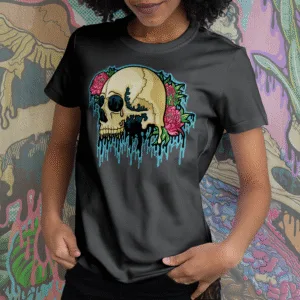 Black t-shirt featuring a vibrant illustration of a cream and teal melting skull accented with pink peonies and green foliage, gothic floral art by illymakes.