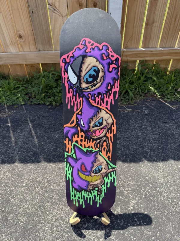 Original acrylic skateboard deck featuring drippy skull designs of Gastly, Haunter, and Gengar stacked vertically. Painted in neon colors with fluorescent blacklight glow, finished in acrylic gloss. Unique 1 of 1, signed and labeled on the back. Stand not included.