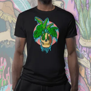Drippy Tropical Skull graphic tee in black, featuring a melting skull with lush monstera leaves and vibrant heliconia flowers.
