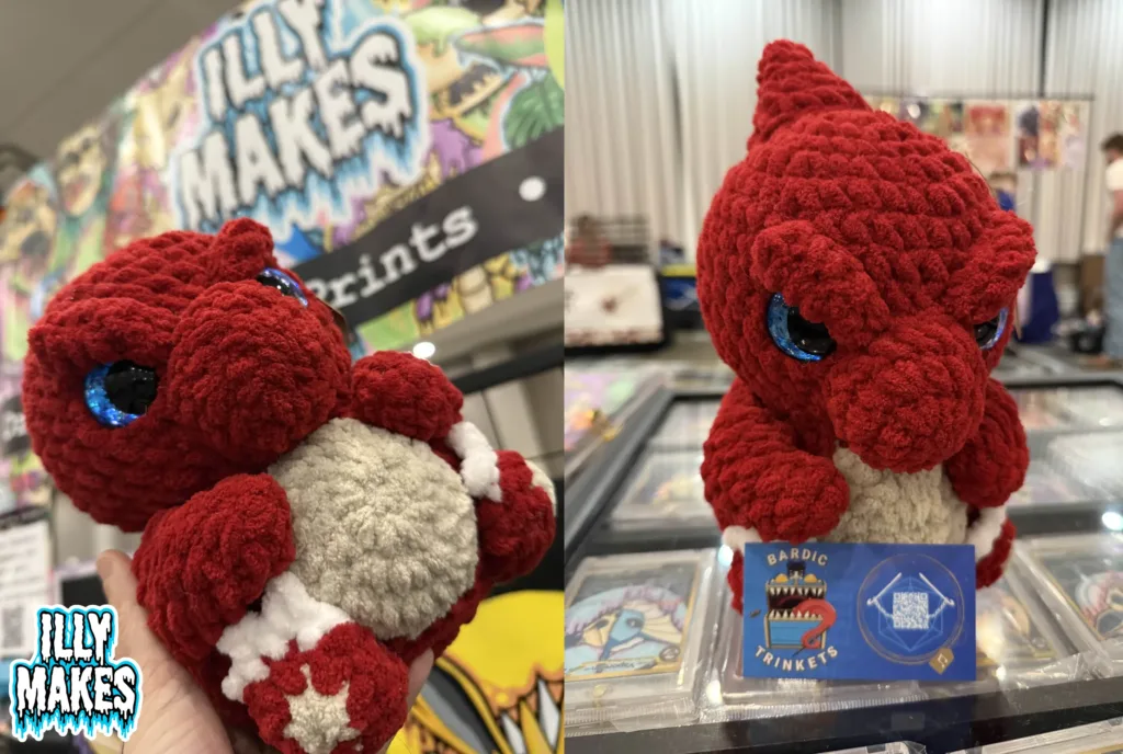 Handmade orange crochet Charmeleon figure created by @BardicTrinkets, displayed in my hand.